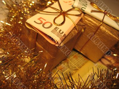 Two golden gift boxes with money
