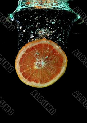 Grapefruit falling into water