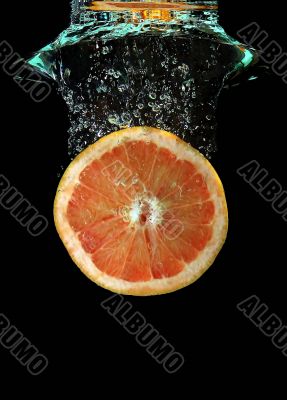 Grapefruit falling into water