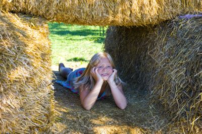 Cute girl on haybales