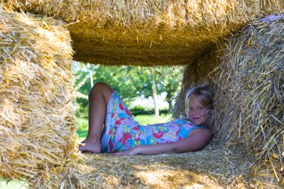 Cute girl on haybales