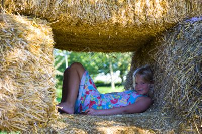 Cute girl on haybales