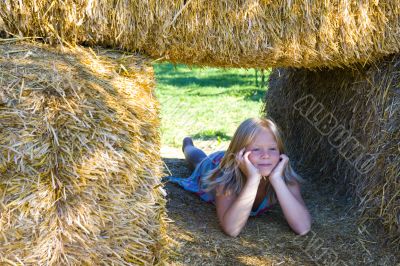 Cute girl on haybales