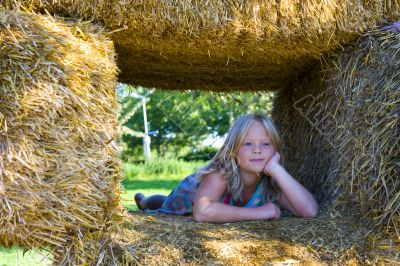 Cute girl on haybales