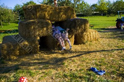 Cute girl on haybales