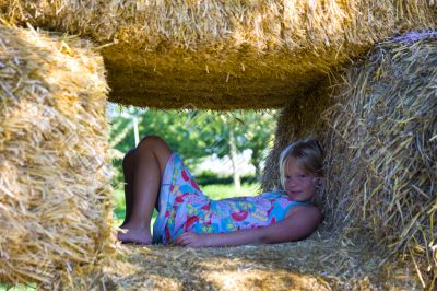 Cute girl on haybales