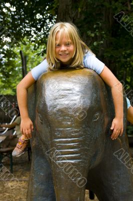 Girl sitting on elephant
