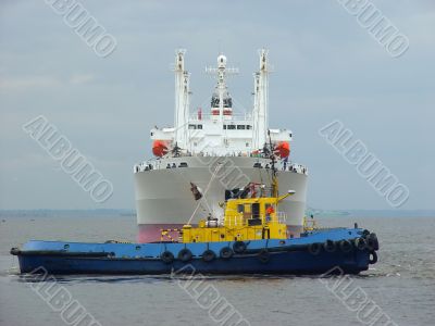 Tugboat towing a ship.