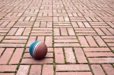 Ball on a pavement tiles