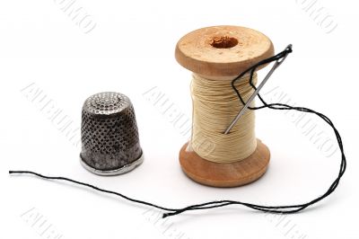 Old thimble,  A sewing needle