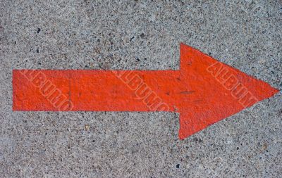 Red Painted Arrow on Concrete