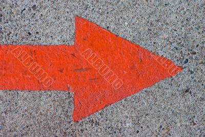 Red Painted Arrow on Concrete