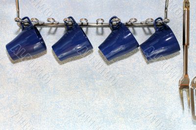 four dark blue cups