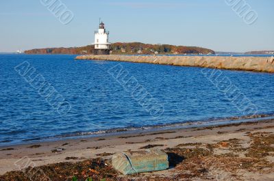 lighthouse, beach, and breakwater