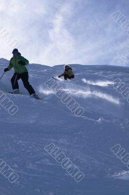 Yellow skiers in powder snow