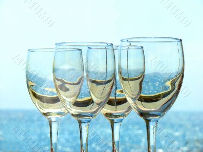 Wine glasses on a background of the sea