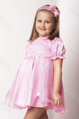 Nice young girl in pink on light background