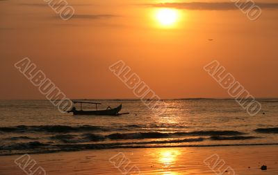Drifting boat on a sunset