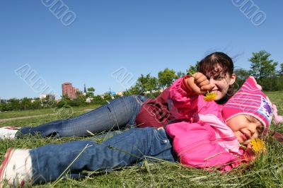 little pretty girl and mother in spring time