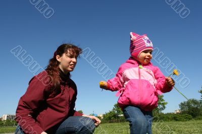 little pretty girl and mother in spring time