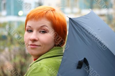 young red-haired woman with umbrella