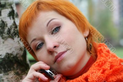 young red-haired woman with umbrella