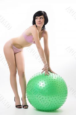 The beautiful girl in bikini and fitness-sphere