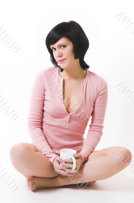 The  girl in pink linen with a cup in hands