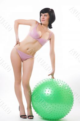 The beautiful girl in bikini and fitness-sphere