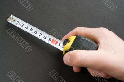 Hand with a measuring tape