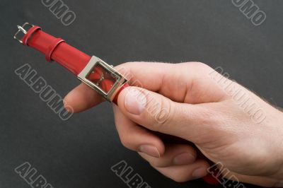 Hand with red watch