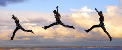 Leaping woman at sunset