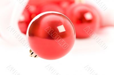 Red christmas balls in Santa hat on white