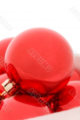 Red christmas balls in fur hat. Close-up