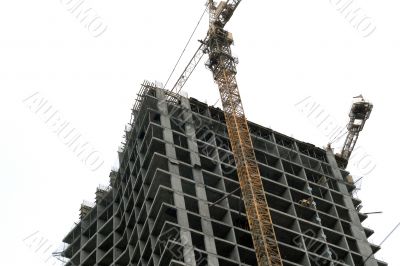 Construction of a tall modern office building.