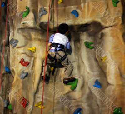 Little boy Climbing A Wall