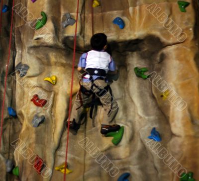 Little boy Climbing A Wall