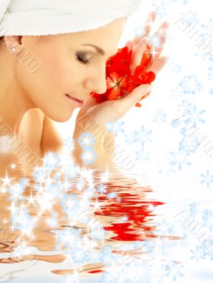 lady with red petals and snowflakes in water