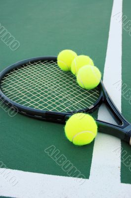 Tennis Racket and balls on court