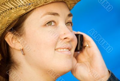casual woman wearing a hat on the phone