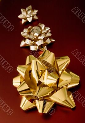 golden ribbons on red gifts