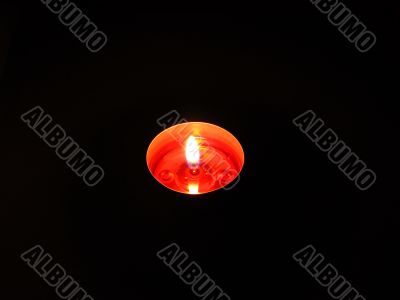 Single candle isolated on black