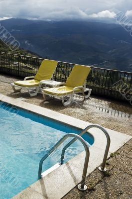 Long chairs by the pool 3