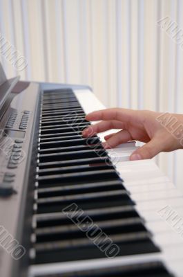 A hand playing piano