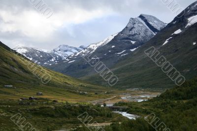 Valley and snow mountain peak in Norway