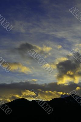 Sunset with clouds and mountains