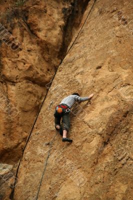 Climber on sheer rock face