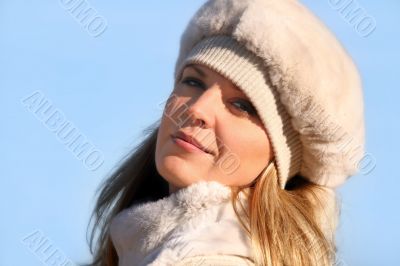 Blond girl in a fur hat