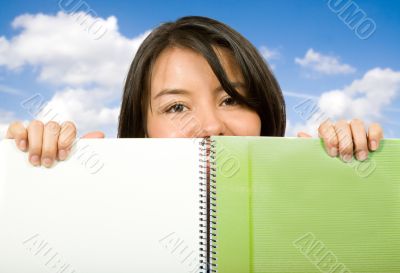 beautiful student looking over notebook