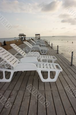 Chaise longues on pier